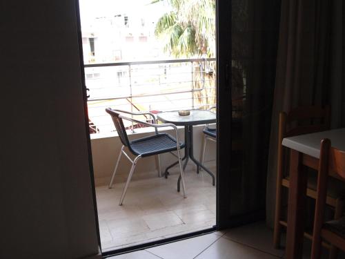 a room with a table and a chair on a balcony at Saint Constantine Hotel in Kos Town