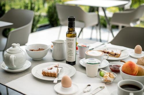 a table with plates of food and a bottle of wine at Agritur Comai in Riva del Garda