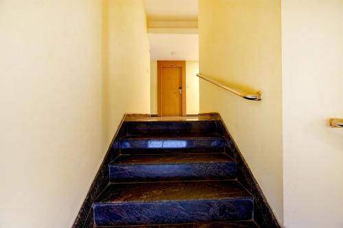 a stairway with blue steps in a building at FabHotel Abirami Grand Inn - Nr Bryant Park in Kodaikānāl