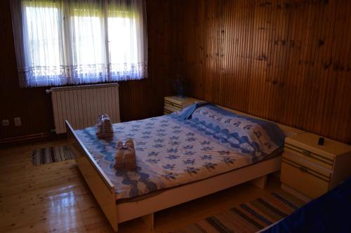 a bedroom with a bed with two babies sitting on it at Šurička bajka in Loznica