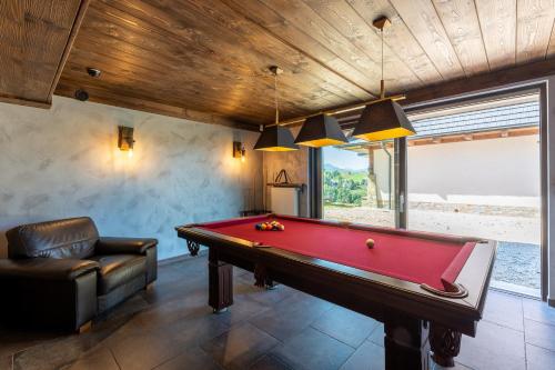 a billiard room with a pool table and a couch at TatrApart in Zakopane
