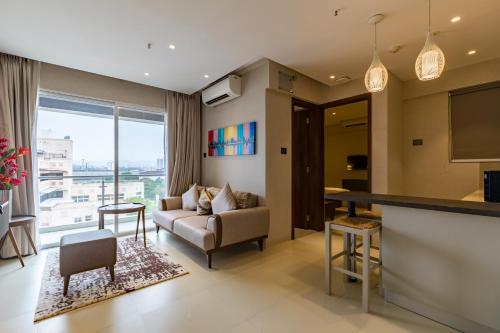 a living room with a couch and a table at AR Suites Jewels Royale - Koregaon Park NX in Pune