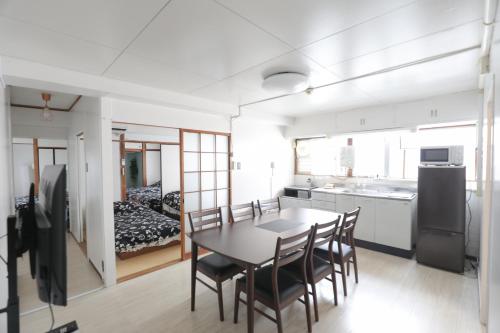 a kitchen and dining room with a table and chairs at Fukuoka Condominium in Fukuoka