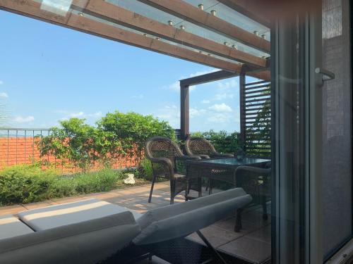 a patio with a table and chairs and a window at Apartmán Pálava - 1 in Pavlov