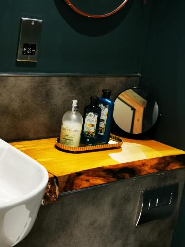 a bathroom counter with a sink and a mirror at Drumdelgie Cottages in Huntly