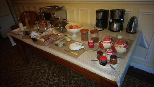 a table with food and other items on it at La Nouvelle Criqueboise in Criquebeuf-en-Caux
