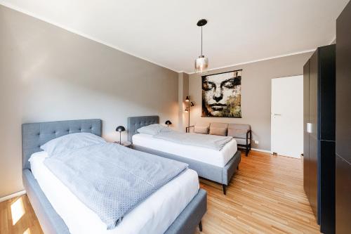 a bedroom with two beds and a painting on the wall at Kambrium in Münster