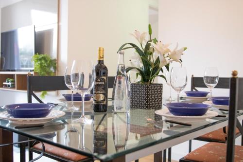 a dining room table with wine bottles and glasses at 3 Quartos, espaçoso, Shopping Raposo in Sao Paulo