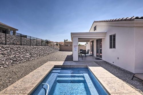 a swimming pool in front of a house at Luxe Home with OHV Access, 5 Mi to Lake Mohave! in Bullhead City