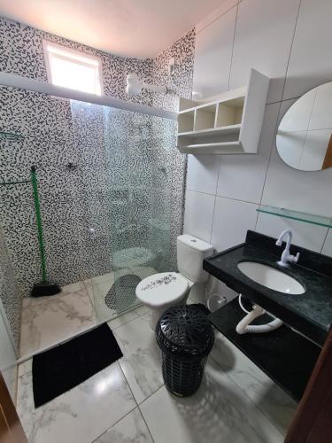 a bathroom with a shower and a toilet and a sink at cobertura jangadeiro RUA JANGADEIROS 215 in Maragogi