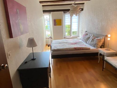 a small bedroom with a bed and a table at Joline private guest apartment feel like home in Nidau