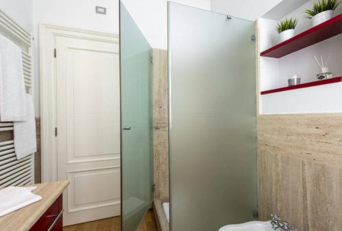 a bathroom with a glass shower stall and a toilet at Milan Royal Suites - Centro in Milan