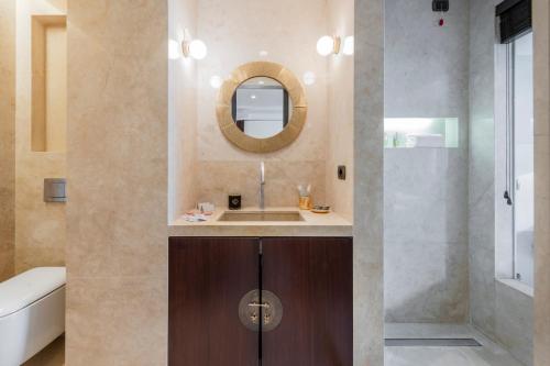 a bathroom with a sink and a mirror at Milan Royal Suites - Centro in Milan