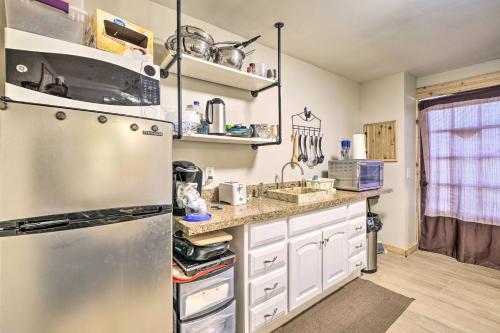 a kitchen with a stainless steel refrigerator and white cabinets at Farmhouse Apt on Route 66 - 12 Miles to Downtown in Tulsa