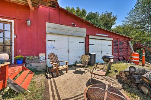 a red barn with three chairs and a grill at Farmhouse Apt on Route 66 - 12 Miles to Downtown in Tulsa