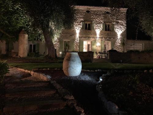 a large white vase sitting in front of a house at night at le mas des roses 1884 in Vence
