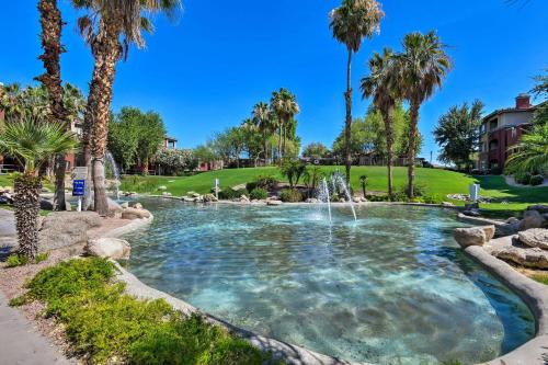 a pool with a waterfall in a park with palm trees at Red Rox Phoenix Condo with Patio about 3 Mi to Airport in Phoenix