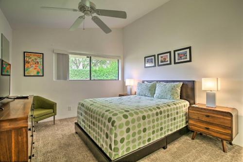 a bedroom with a bed and a desk and a ceiling fan at Palm Springs Retreat with Pool Access, Near Downtown in Palm Springs