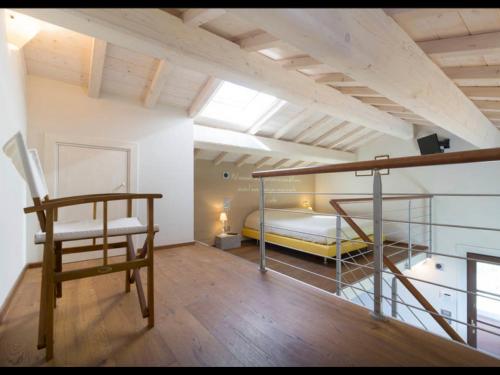a bedroom with a bunk bed and a chair at Podere Raffanna Ecologic House in Massa e Cozzile