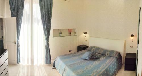 1 dormitorio con cama y ventana grande en Bed & Breakfast Toledo, en Nápoles
