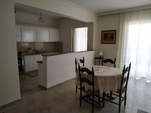 a kitchen and dining room with a table and chairs at Vangelis apartment near Athens Airport in Spata