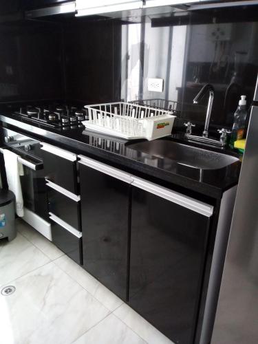 a kitchen with a sink and a stove at MIRADOR TUNJA 401 in Tunja