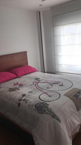 a bedroom with a bed with a painting on it at MIRADOR TUNJA 401 in Tunja