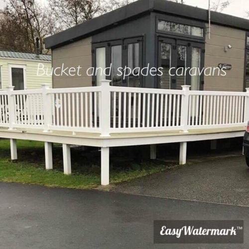 a black and white house with a white railing at Blackpool caravans Marton mere in Blackpool