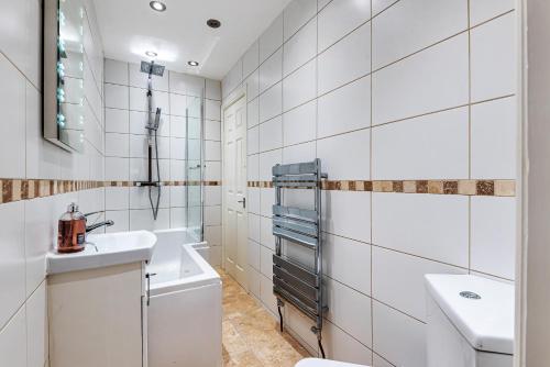a white bathroom with a sink and a toilet at Locket Studio - Cosy Apartment with Balcony in York
