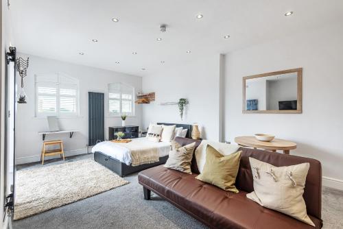 a living room with a couch and a bed at Locket Studio - Cosy Apartment with Balcony in York
