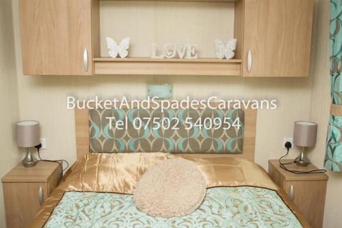 a bedroom with a bed with butterflies on it at Blackpool caravans Marton mere in Blackpool