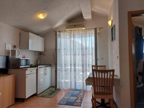 a kitchen with a window and a table and a chair at The best location in Makarska,free P, option bikes in Makarska