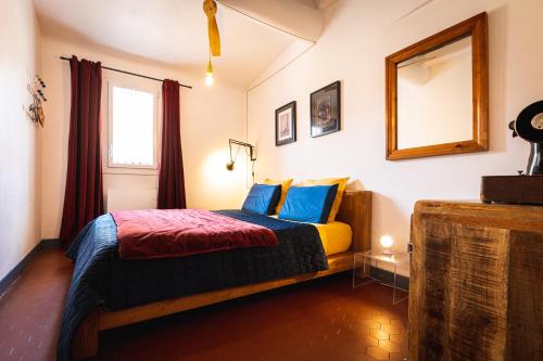 une chambre avec un lit et un miroir au mur dans l'établissement Lumineux Aix Plein Centre avec Parking privé Gratuit, à Aix-en-Provence