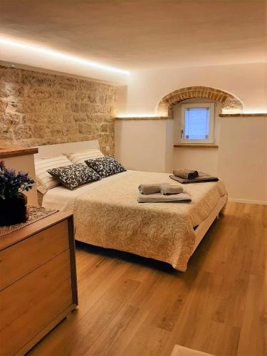 a large bedroom with two beds and a window at Appartamento Gattapone 9 in Gubbio