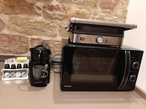 a microwave sitting on a counter next to a coffee maker at Appartamento Gattapone 9 in Gubbio