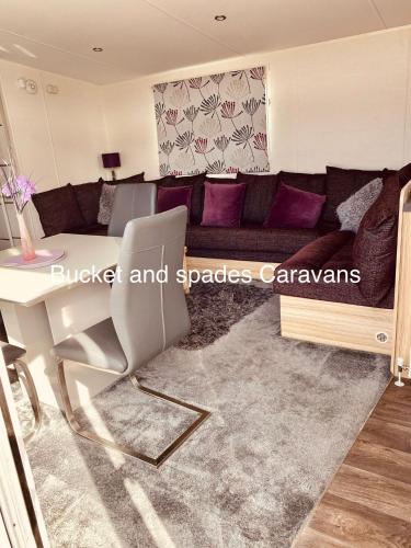 a living room with a couch and a table at Blackpool caravans Marton mere in Blackpool