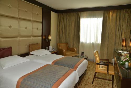 Ένα ή περισσότερα κρεβάτια σε δωμάτιο στο Hôtel Farah Casablanca