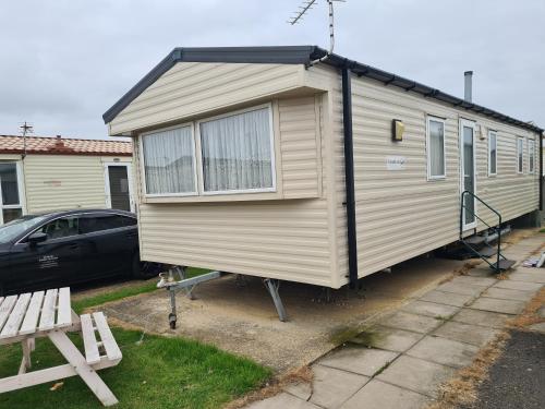 a small beige trailer parked in a driveway at 8 Berth on Coastfields Ingoldmells (Vacation) in Ingoldmells