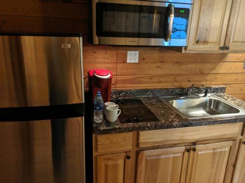 a kitchen with a stainless steel refrigerator and a sink at Stateline Cabin in Hobbs