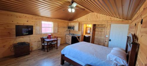 a bedroom with a bed in a wooden cabin at Stateline Cabin in Hobbs