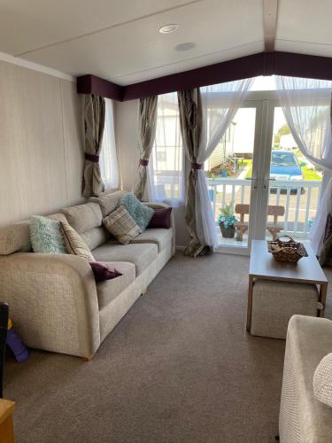 a living room with a couch and a table at Blackpool caravans Marton mere in Blackpool