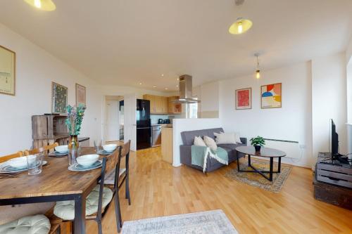 a living room with a table and a couch at Cozy Hackney Apartment in London