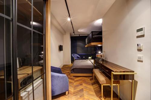 a small room with a bed and a desk and a bedroom at Concept Nisantasi Hotels & Spa in Istanbul