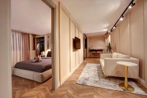 a bedroom with a bed and a couch and a table at Concept Nisantasi Hotels & Spa in Istanbul