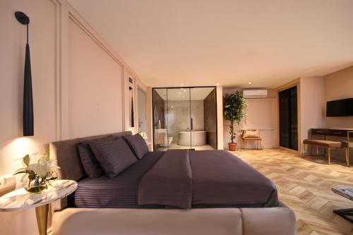 a bedroom with a large bed and a living room at Concept Nisantasi Hotels & Spa in Istanbul