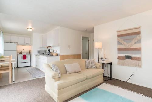 a living room with a couch and a kitchen at Unique, Convenient, Centrally located apartment in Kent