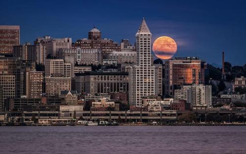 a city with a large moon in the sky at Unique, Convenient, Centrally located apartment in Kent