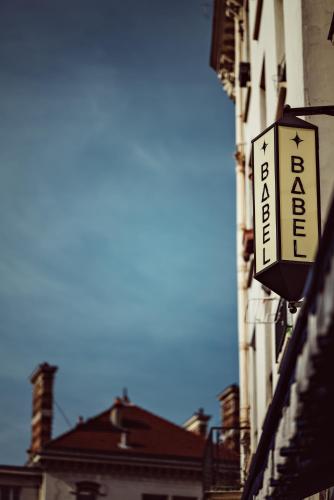 a sign for a hotel on the side of a building at Babel Belleville in Paris