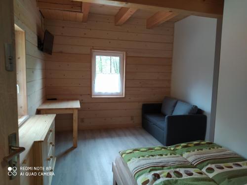 a small room with a bed and a window at Rodinný penzion U Hafana a U Hospůdky in Řeka