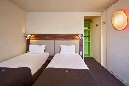Ein Bett oder Betten in einem Zimmer der Unterkunft Campanile Melun Sénart